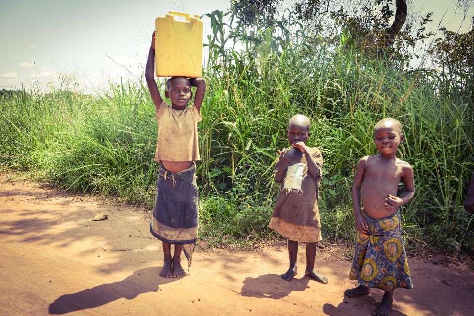 ugandan-children-carrying-water-home-photo-copyright-protected-by-dora-leticia-limited-use-only-with-written-permission-required-no-extended-use